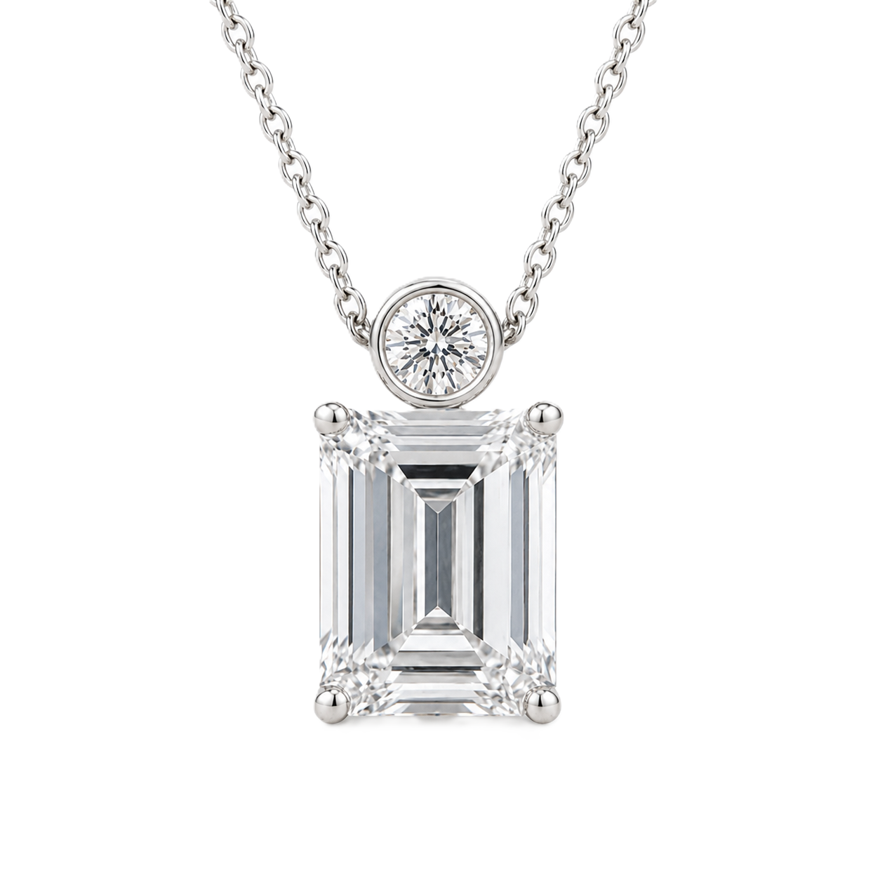 Emerald cut Moissanite pendant with 7×5 mm center stone and bezel-set round accent in white gold plated 925 silver. Elegant everyday luxury by BSI Jewelry.
