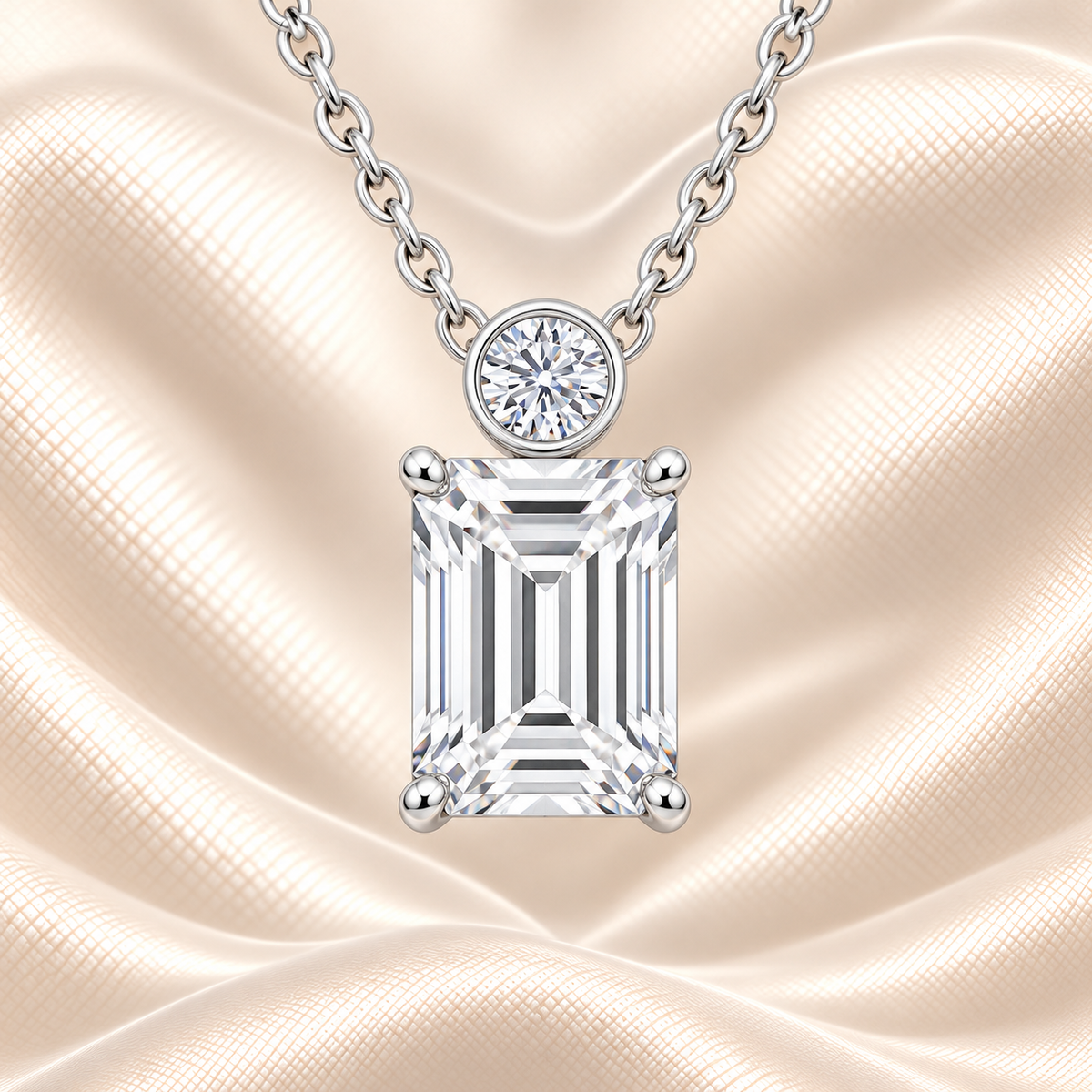 Emerald cut Moissanite pendant with 7×5 mm center stone and bezel-set round accent in white gold plated 925 silver. Elegant everyday luxury by BSI Jewelry.
