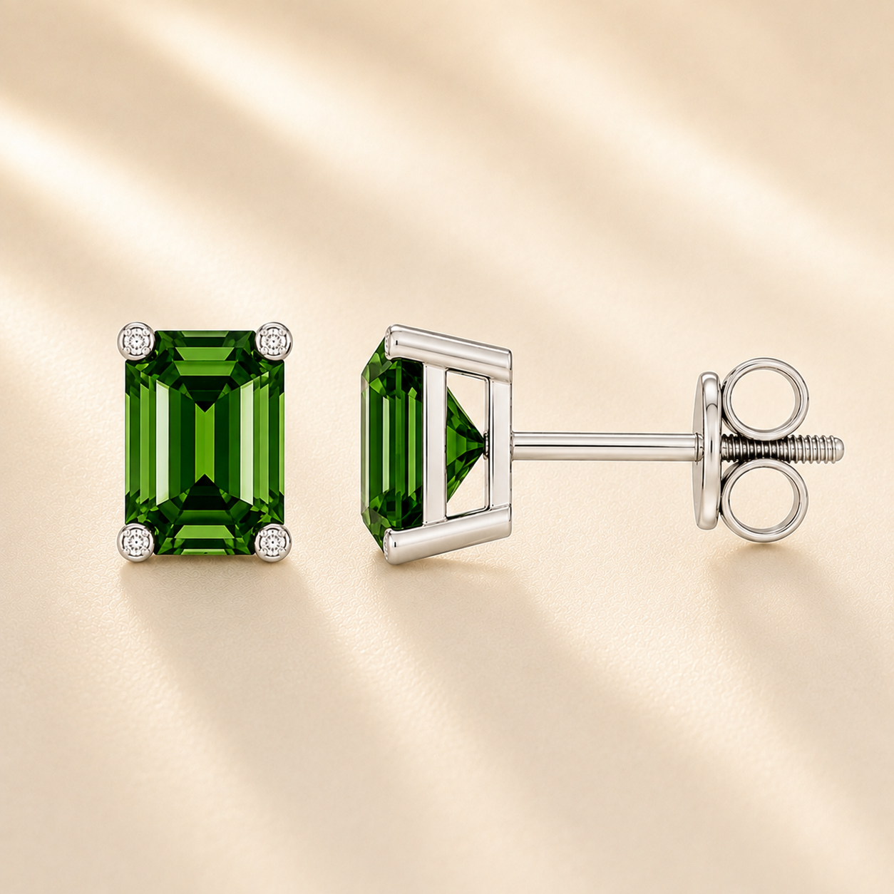 Emerald green sapphire stud earrings with 6×4 mm stones and moissanite prongs in white gold plated 925 silver. Available now at BSI Jewelry.