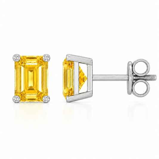 Emerald yellow sapphire stud earrings with 6×4 mm stones and moissanite prongs in white gold plated 925 silver. Available now at BSI Jewelry.