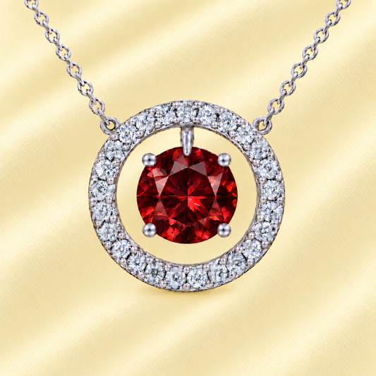 Garnet necklace with a 6 mm round gemstone and moissanite halo in white gold-plated 925 silver. Elegant and radiant. Available now at BSI Jewelry.