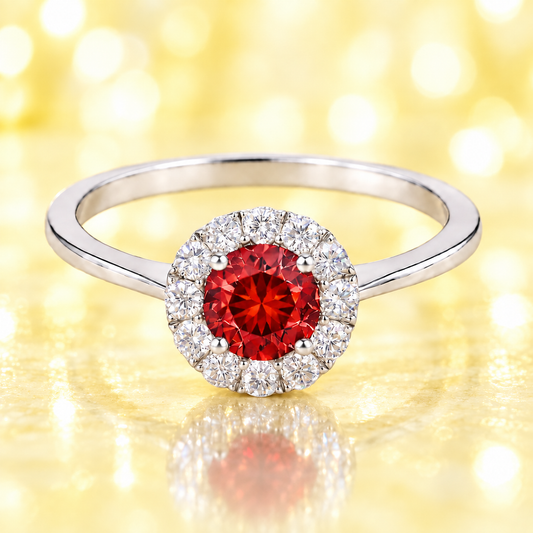 Garnet ring with a 4.50 mm round-cut stone in white gold-plated 925 silver, accented with moissanite for rich red brilliance. Available now at BSI Jewelry.