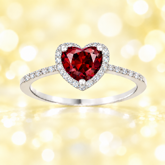 Garnet ring with a 6 mm heart cut, crafted in white gold-plated 925 silver and accented with moissanite. Available now at BSI Jewelry.