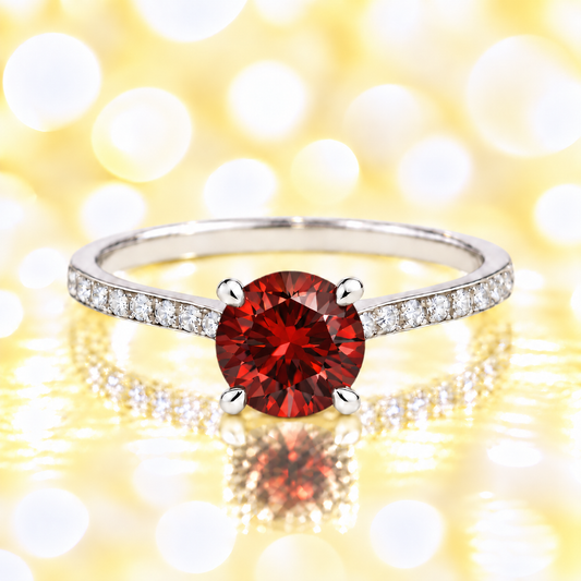 Garnet ring with a 6 mm round-cut and moissanite accents, crafted in white gold-plated 925 silver. Elegant for daily wear. Available now at BSI Jewelry.