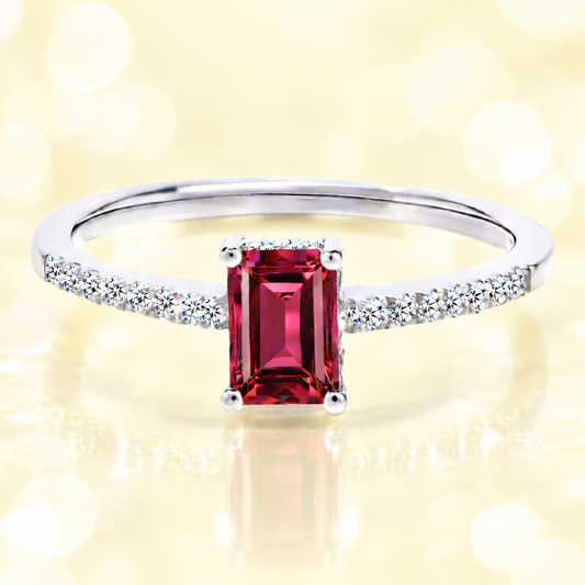 Garnet ring with a 7×5 mm emerald cut in white gold-plated 925 silver, with moissanite. Elegant and refined for daily wear. Available now at BSI Jewelry.