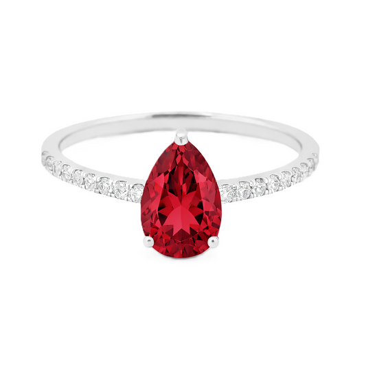 Garnet ring with a 7×5 mm pear-cut stone and moissanite accents in white gold plated 925 silver. Elegant for daily wear. Available now at BSI Jewelry.