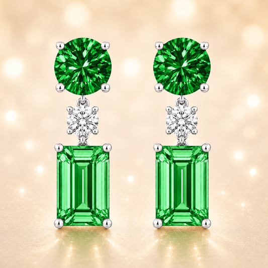 Green sapphire drop earrings with 5mm round and 6×4mm emerald-cut, crafted in white gold-plated 925 silver with palladium-added alloy. Available at BSI Jewelry.