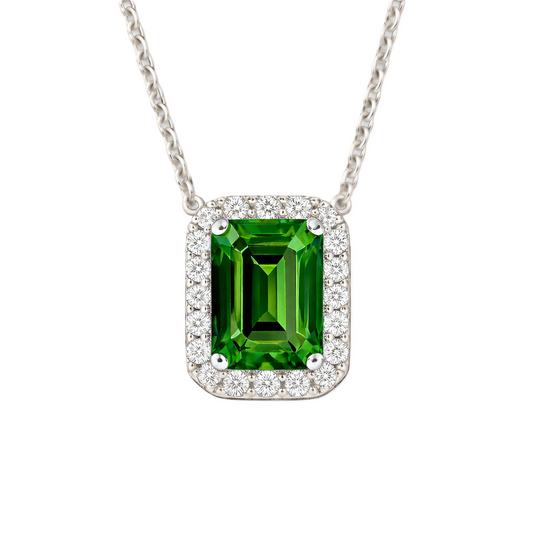 Vibrant green sapphire halo necklace featuring a 7×5 mm emerald-cut gemstone in white gold-plated 925 silver. Available now at BSI Jewelry.