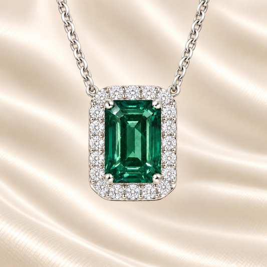 Vibrant green sapphire halo necklace featuring a 7×5 mm emerald-cut gemstone in white gold-plated 925 silver. Available now at BSI Jewelry.
