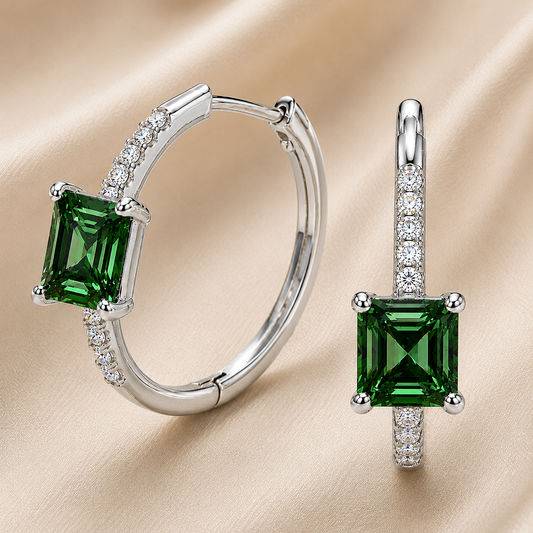 Green sapphire huggie earrings featuring vibrant 5 mm square green sapphires and sparkling accents in white gold plated 925 silver. Available now at BSI Jewelry.