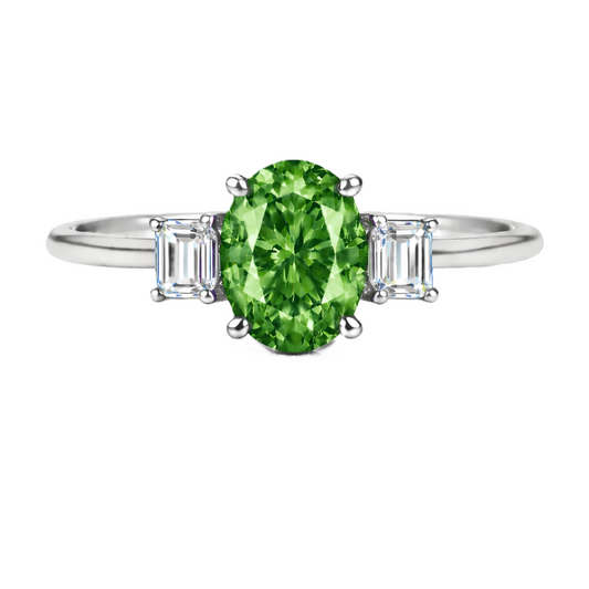 Green sapphire ring with 7×5 mm oval center and 5×3 mm moissanite sides in white gold-plated 925 silver. Elegant and refined. Available now at BSI Jewelry.