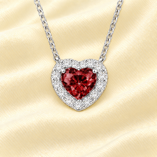 Garnet heart necklace with a 6 mm gemstone in white gold-plated 925 silver. Elegant and hypoallergenic. Available now at BSI Jewelry.
