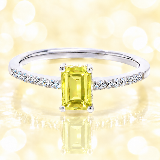 Lemon quartz ring with a 7×5 mm emerald cut in white gold-plated 925 silver, with moissanite. Elegant and refined for daily wear. Available now at BSI Jewelry.
