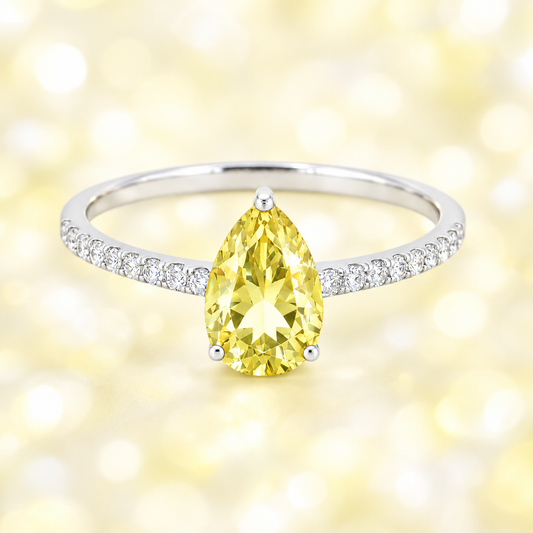 Lemon quartz ring with a 7×5 mm pear-cut stone and moissanite accents in white gold plated 925 silver. Elegant for daily wear. Available now at BSI Jewelry.