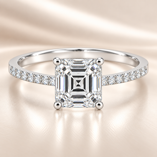 Moissanite asscher ring with a 6 mm asscher-cut stone, accented by moissanite in white gold-plated 925 silver. Sleek and refined. Available now at BSI Jewelry.
