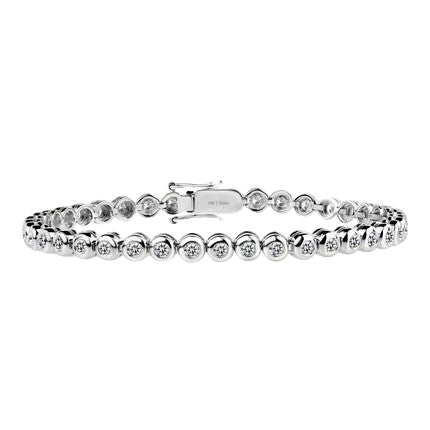 Moissanite bezel tennis bracelet in white gold-plated 925 silver, brilliant stones set in smooth bezels for timeless sparkle. Available now at BSI Jewelry.
