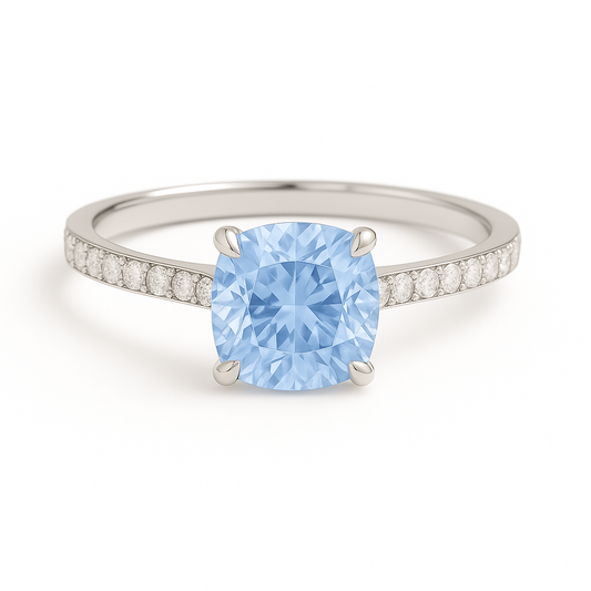Elegant 7 mm cushion blue sapphire ring accented with Moissanite, crafted in white gold-plated 925 silver with palladium alloy. Available now at BSI Jewelry.