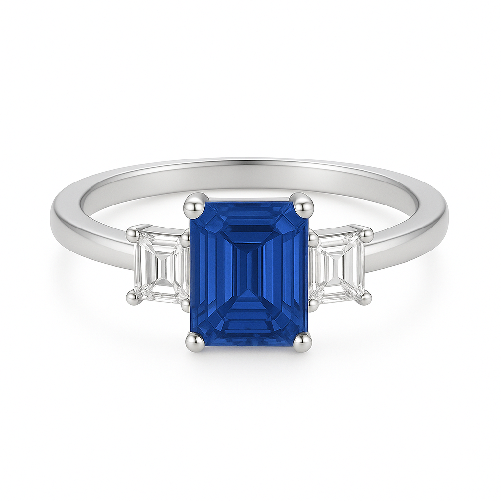 7×5 mm emerald-cut blue sapphire ring with baguette Moissanite accents in white-gold-plated 925 silver. Brilliant color and timeless charm. Now at BSI Jewelry.
