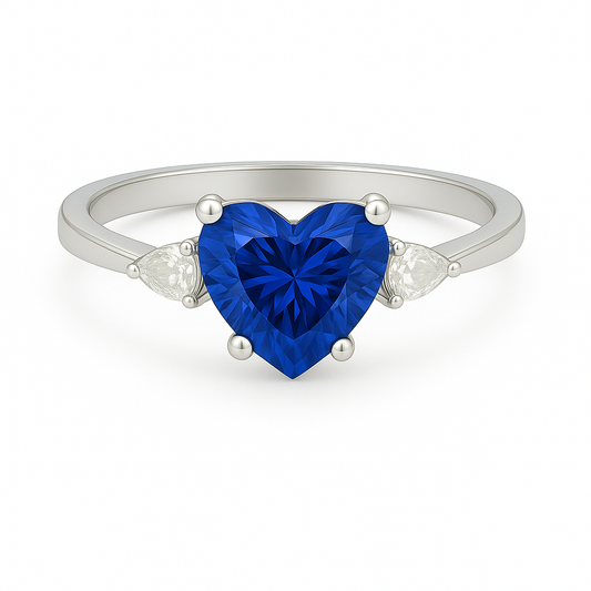 6 mm heart-cut blue sapphire ring with pear-shaped Moissanite accents, set in white-gold-plated 925 silver. Romantic and charming. Available now at BSI Jewelry.