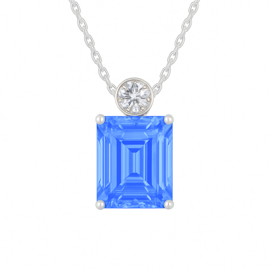 Blue sapphire & Moissanite pendant with 7×5 mm emerald-cut stone in white gold-plated 925 silver. Elegant sparkle and hypoallergenic. Available at BSI Jewelry.