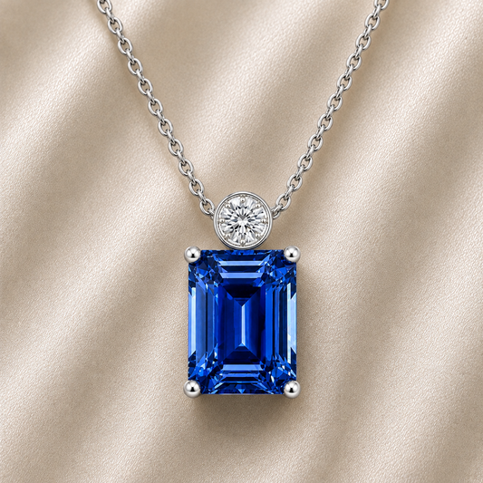 Blue sapphire & Moissanite pendant with 7×5 mm emerald-cut stone in white gold-plated 925 silver. Elegant sparkle and hypoallergenic. Available at BSI Jewelry.