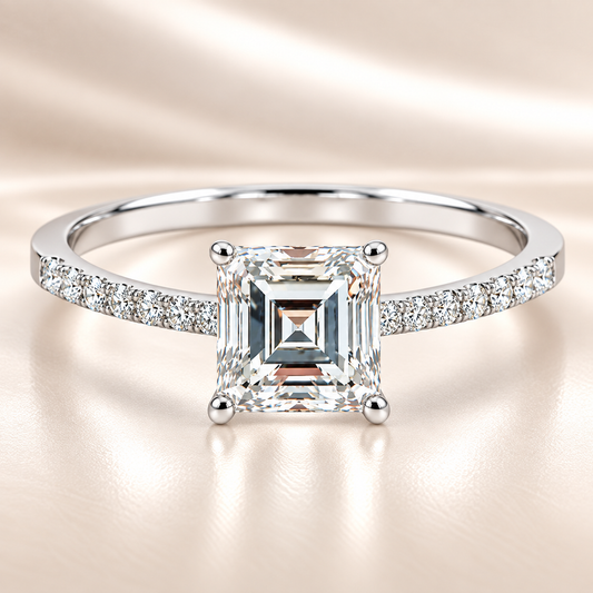Moissanite carré ring with a 6 mm square-cut stone, accented by moissanite in white gold-plated 925 silver. Modern and refined. Available now at BSI Jewelry.