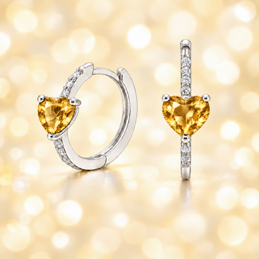 Heart-cut Citrine huggie earrings in white-gold-plated 925 silver with sparkling Moissanite accents for warm golden brilliance. Available now at BSI Jewelry.