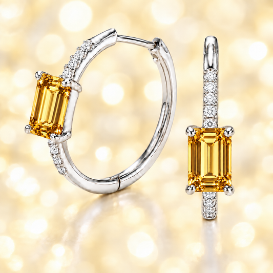 Radiant citrine and Moissanite huggie earrings with 6×4 mm emerald-cut stones in white gold-plated 925 silver. Hypoallergenic comfort. Now at BSI Jewelry.