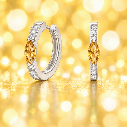 Citrine and Moissanite marquise huggie earrings in white gold-plated 925 silver with 6×3 mm stones. Hypoallergenic and safe to wear. Available at BSI Jewelry.