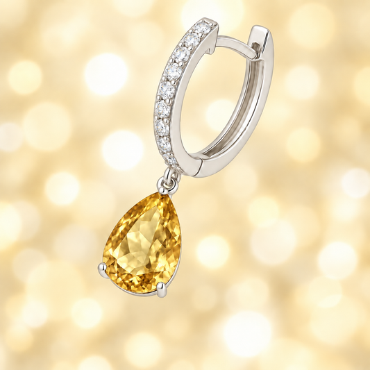Moissanite & Citrine Pear Drop Huggie Earrings, 8×6 mm pear cut, crafted in white gold-plated 925 silver. Vibrant and hypoallergenic. Available at BSI Jewelry.