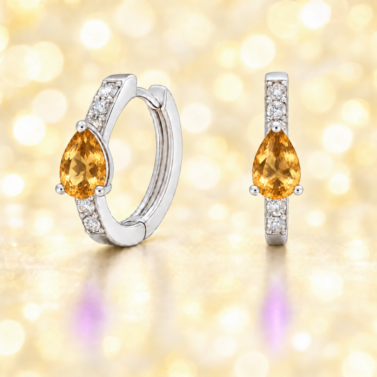 Elegant pear-cut citrine huggie earring in white gold-plated 925 silver with Moissanite accents for timeless sparkle. Available now at BSI Jewelry.