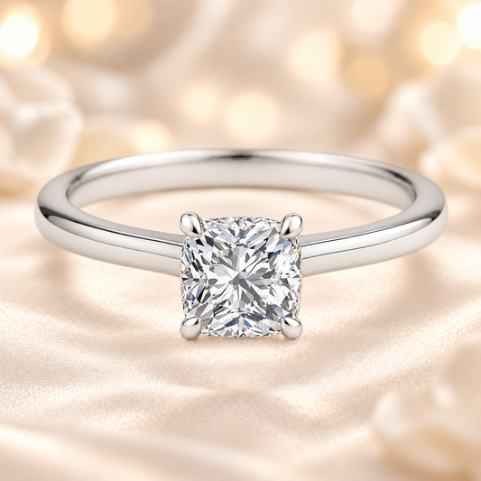 Elegant 5 mm cushion-cut Moissanite solitaire in white gold-plated 925 silver with palladium-added alloy. Hypoallergenic and timeless. Available at BSI Jewelry.