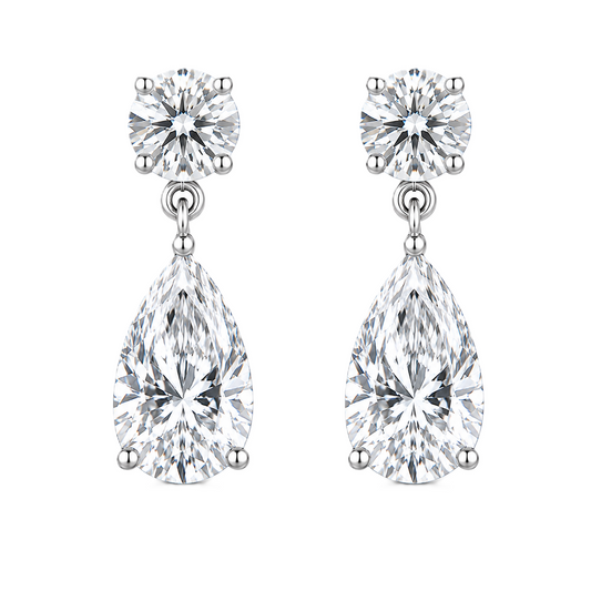 Moissanite Stud Earrings featuring round brilliant and pear cuts, crafted in white gold-plated 925 silver. Graceful and hypoallergenic. Available at BSI Jewelry