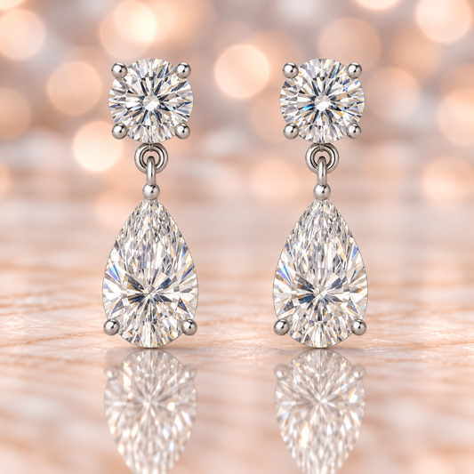 Moissanite Stud Earrings featuring round brilliant and pear cuts, crafted in white gold-plated 925 silver. Graceful and hypoallergenic. Available at BSI Jewelry.