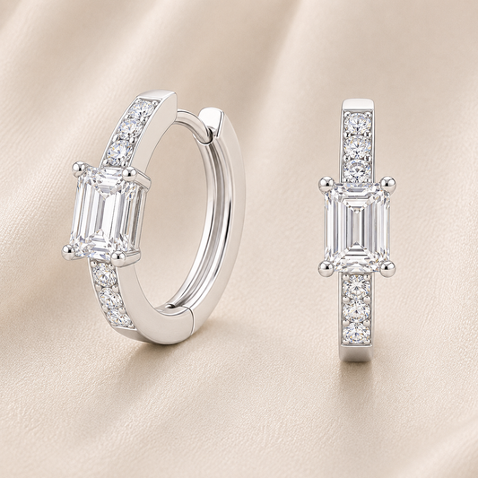 Elegant huggie earrings in white gold-plated 925 silver with a 6×4mm emerald-cut Moissanite for refined brilliance. Available now at BSI Jewelry.