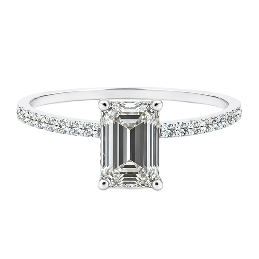 Moissanite emerald ring with a 7×5 mm emerald-cut stone, accented by moissanite in white gold-plated 925 silver. Sleek and elegant. Available now at BSI Jewelry.
