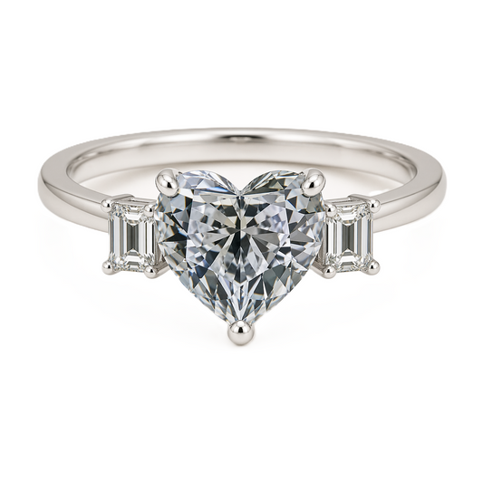 Moissanite engagement ring with 6 mm heart center and emerald accents in white gold-plated 925 silver. Elegant and hypoallergenic. Available now at BSI Jewelry.