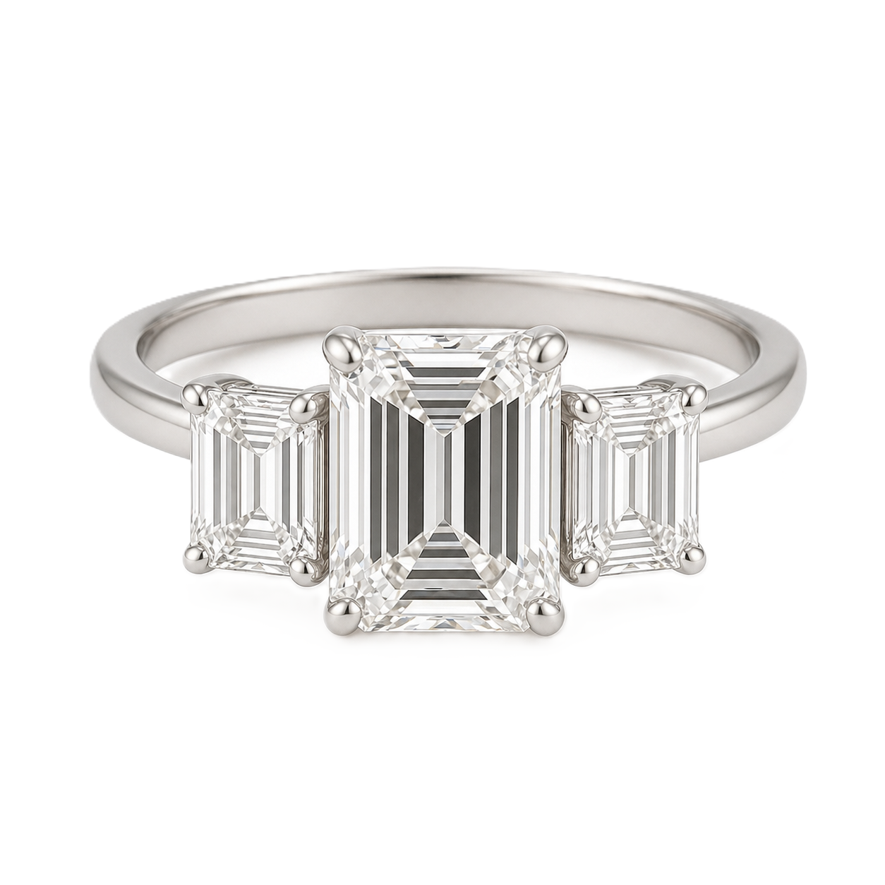 Moissanite engagement ring with 7×5 mm emerald and emerald-cut accents in white gold-plated 925 silver. Elegant and hypoallergenic. Available now at BSI Jewelry.