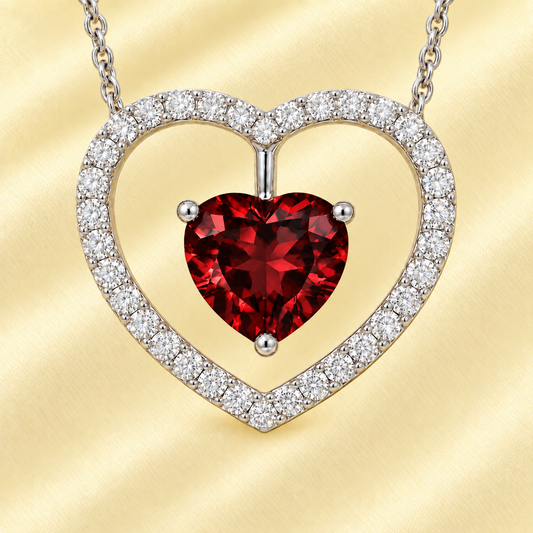 Moissanite and garnet necklace with a 6 mm heart-cut gemstone in white gold-plated 925 silver. Romantic and elegant. Available now at BSI Jewelry.