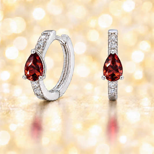 Elegant pear-cut Garnet huggie in white gold-plated 925 silver with Moissanite accents for fresh, versatile sparkle. Available now at BSI Jewelry.