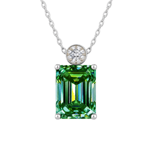 Green sapphire & Moissanite pendant with 7×5 mm emerald-cut stone in white gold-plated 925 silver. Elegant sparkle and hypoallergenic. Available at BSI Jewelry.