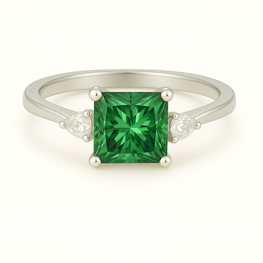 6 mm princess-cut green sapphire ring with Moissanite accents in white-gold-plated 925 silver. Radiant sparkle and timeless elegance. Available at BSI Jewelry.