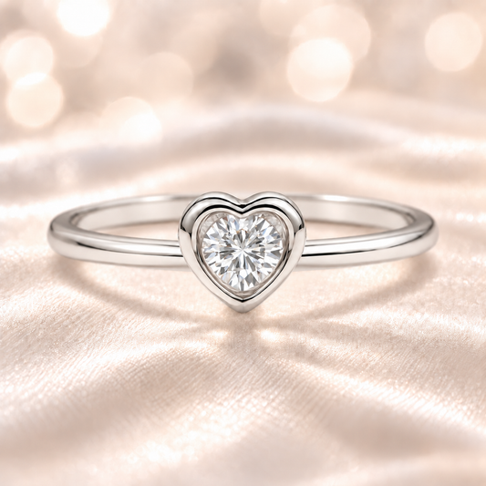 Moissanite heart solitaire ring with 3 mm round center stone, crafted in white-gold-plated 925 silver. Radiant sparkle and elegance. Available at BSI Jewelry.