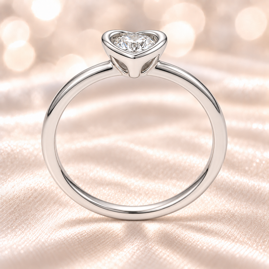 Moissanite heart solitaire ring with 3 mm round center stone, crafted in white-gold-plated 925 silver. Radiant sparkle and elegance. Available at BSI Jewelry.