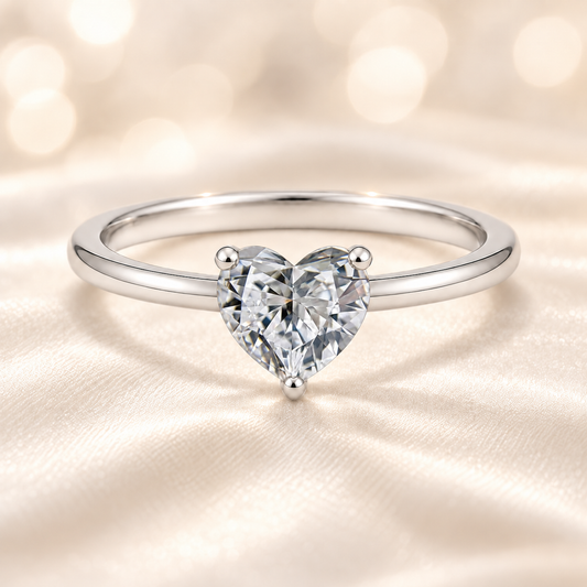 7mm heart-cut Moissanite solitaire in white gold-plated 925 silver with palladium-added alloy. Radiant, elegant, and hypoallergenic. Available now at BSI Jewelry.