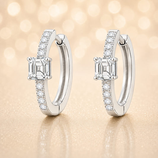 Moissanite huggie earrings, 5 mm Asscher cut in white gold plated 925 silver. Elegant pavé hoop design with brilliant sparkle. Available now at BSI Jewelry.