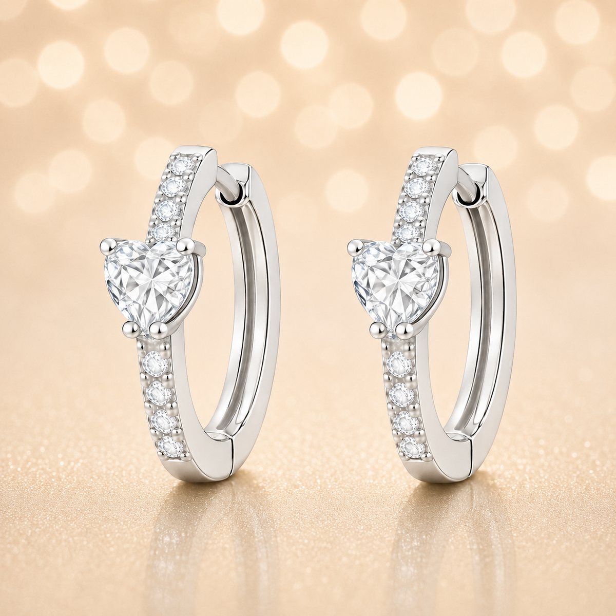 Moissanite huggie earrings featuring a 5 mm heart stone in white gold-plated 925 silver. Elegant sparkle with pavé accents. Available now at BSI Jewelry.