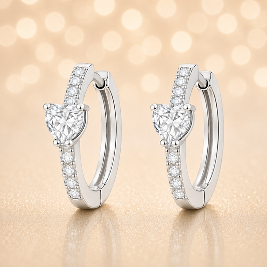 Moissanite huggie earrings featuring a 5 mm heart stone in white gold-plated 925 silver. Elegant sparkle with pavé accents. Available now at BSI Jewelry.