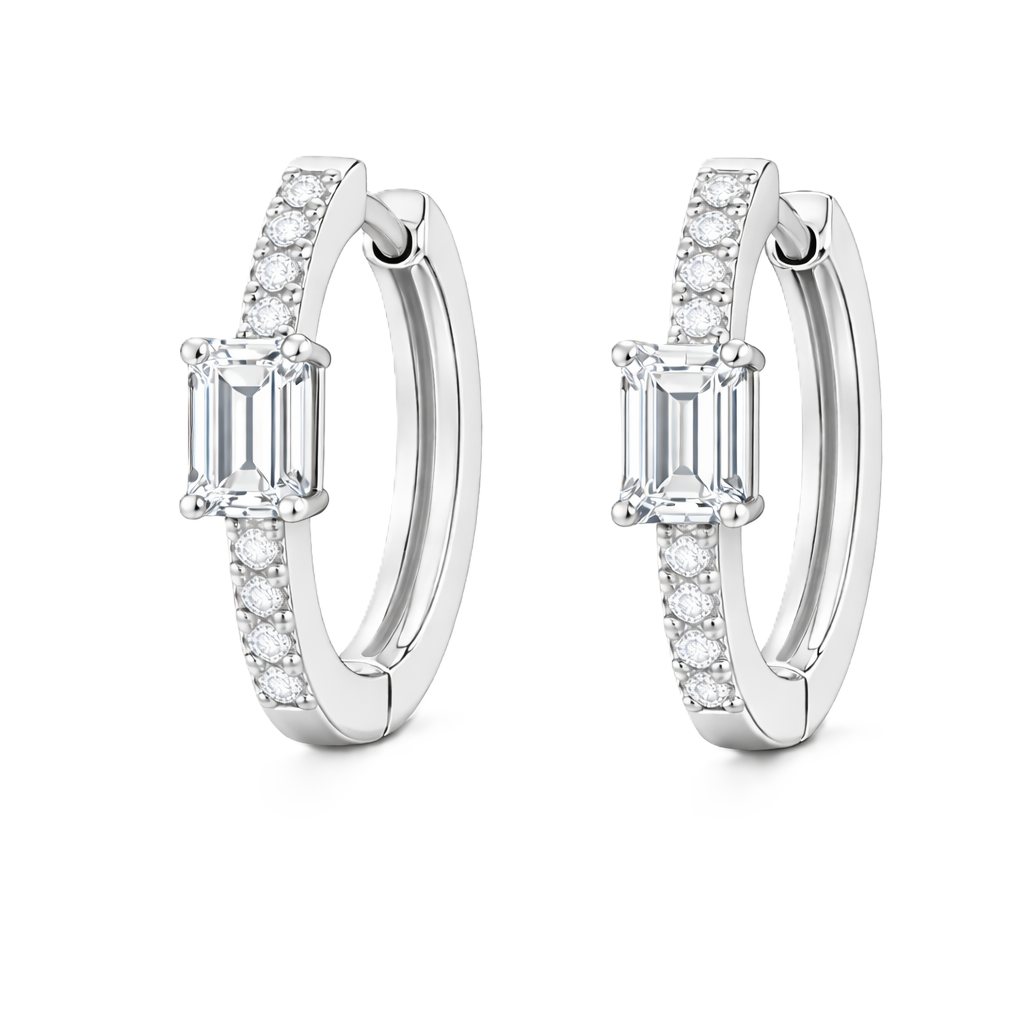 Moissanite huggie earrings, 5×3 mm emerald cut in white gold plated 925 silver. Elegant pavé hoop design with brilliant sparkle. Available now at BSI Jewelry.