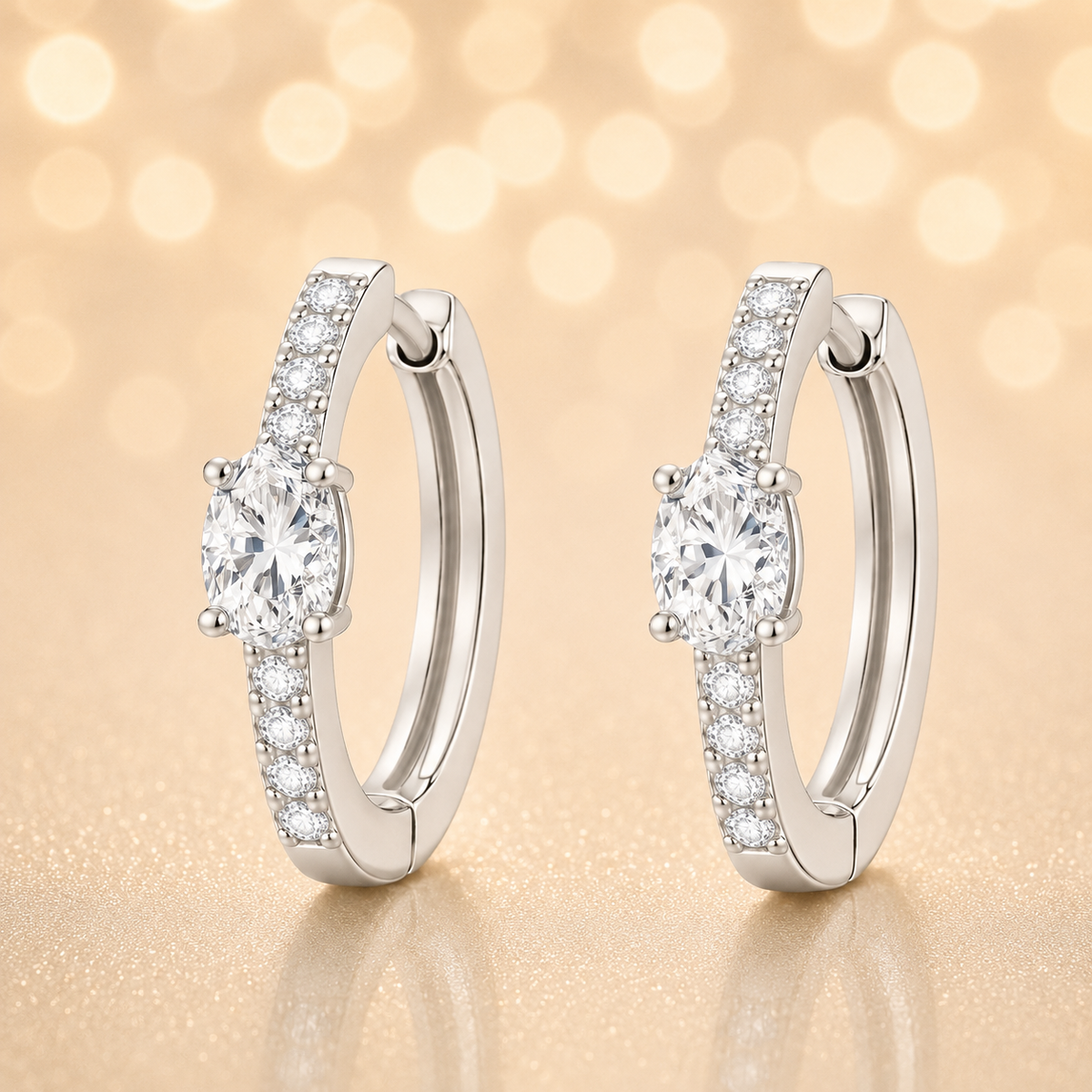 Moissanite huggie earrings, 5×3 mm oval cut in white gold plated 925 silver. Elegant pavé hoop design with brilliant sparkle. Available now at BSI Jewelry.